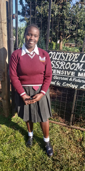 Ann Nyambura at the entrance of
GB garden at her school
