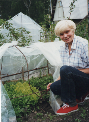 Larissa with a hoophouse